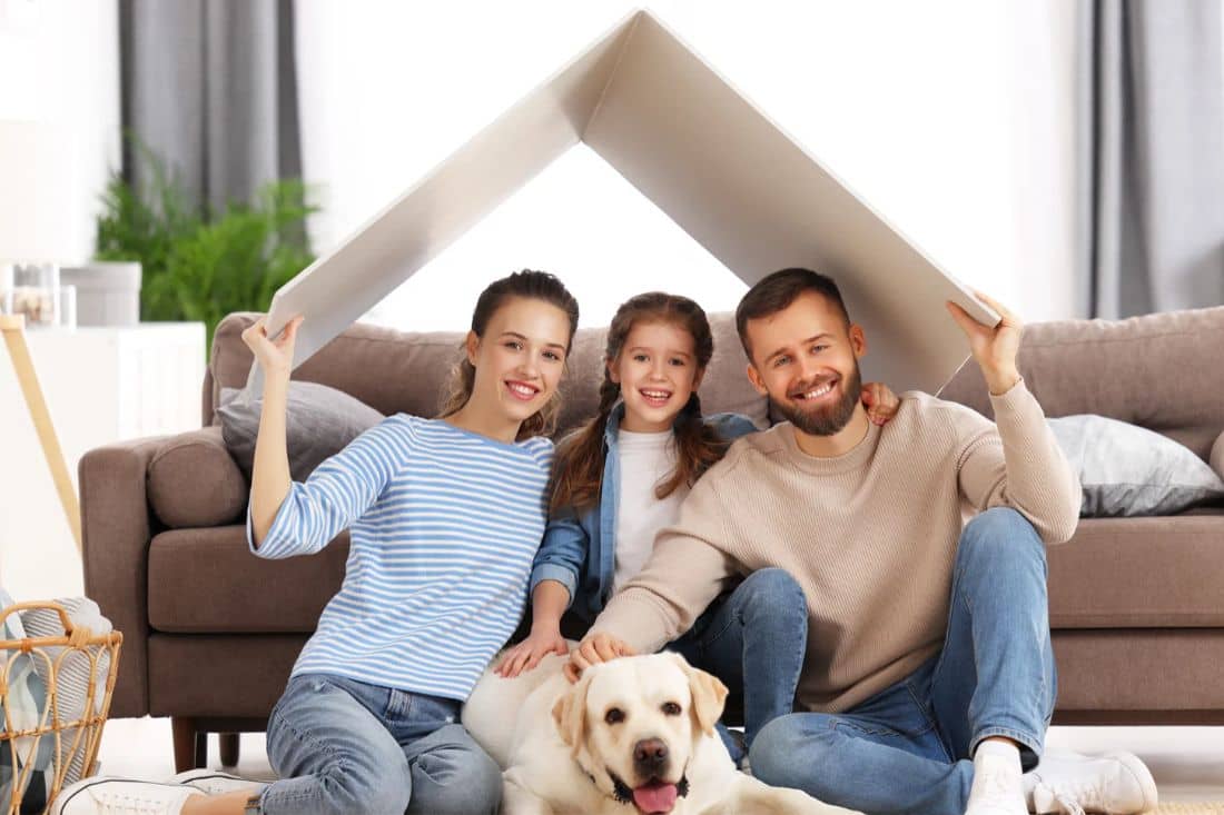 Young family and their dog with new home